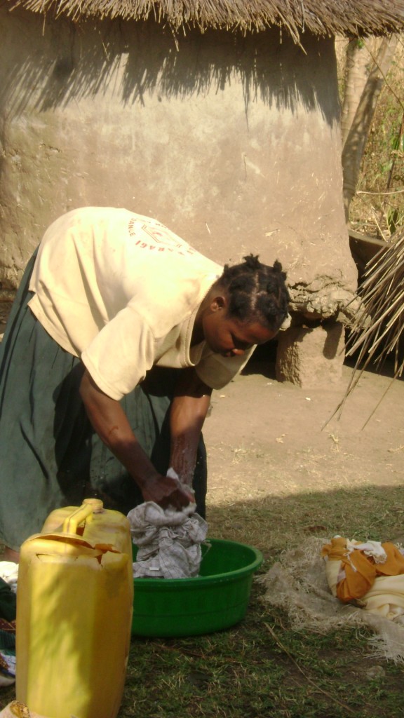 Akello Grace washing at home