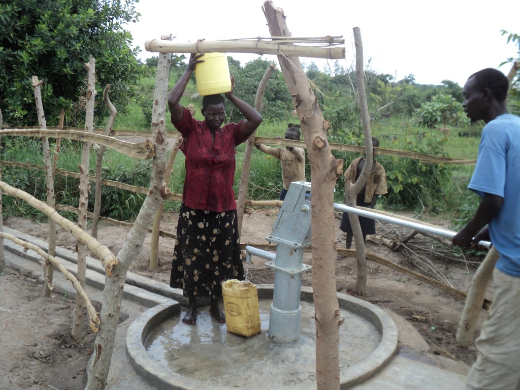 Betty Ocen  of Te- Akang, rejoice the benefit of reduced distant to a new water point
