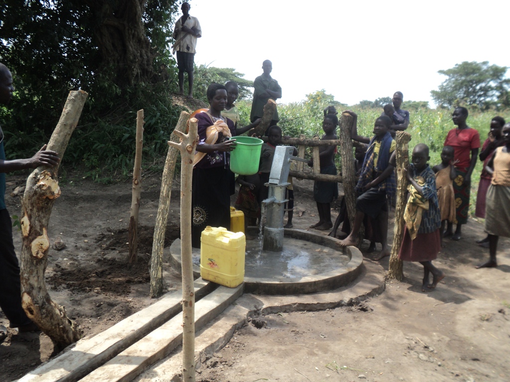 Christine Odong, 29, years cleaning her backet at Alorom welll before fetching clean water
